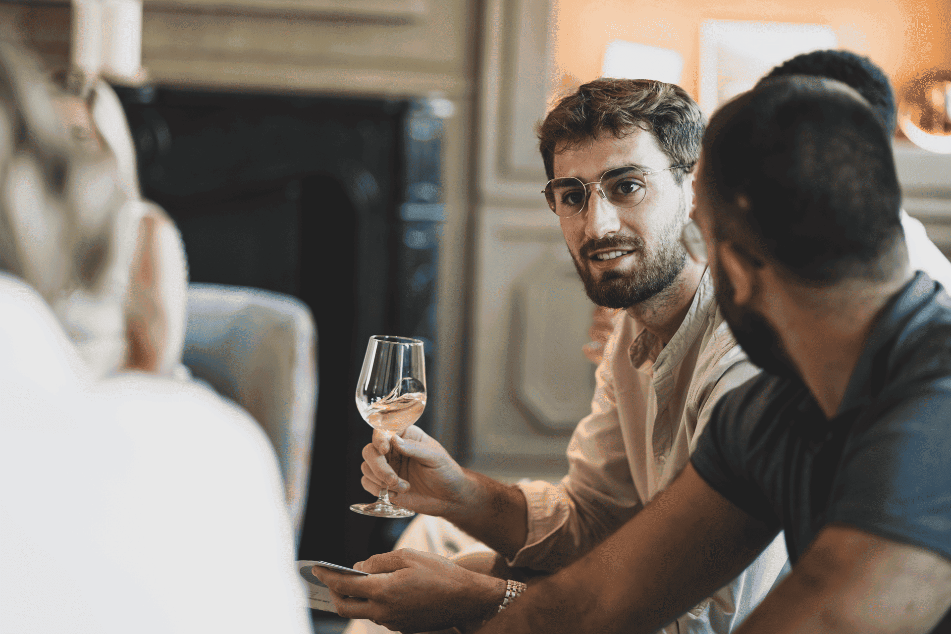 Portrait d'un participant, homme jeune, tentant un verre de vin blanc, lors d'un atelier d'oenologie